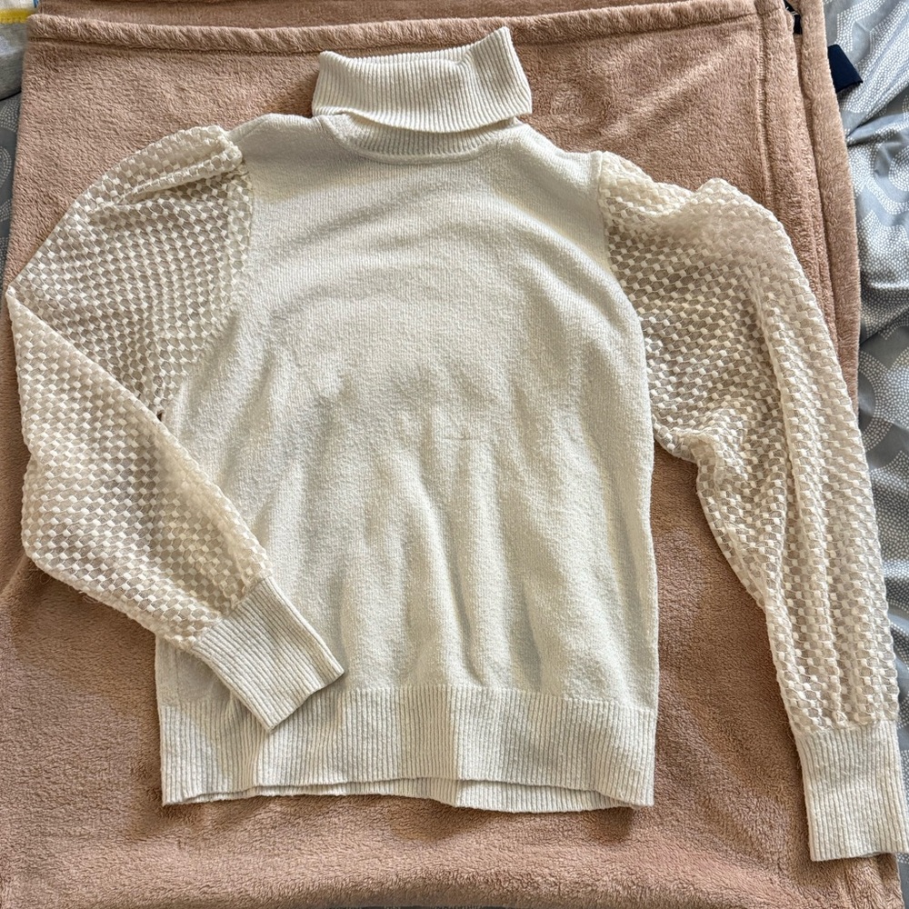 Elegant Cream Turtleneck Sweater with Textured Sleeves